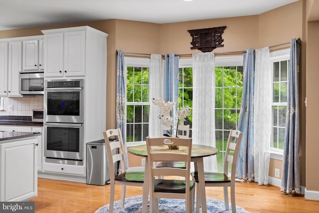 10701 Monocacy Way, Manassas, VA 20112 - kitchen with stainless steel appliances, white cabinetry, light wood-style floors, and backsplash