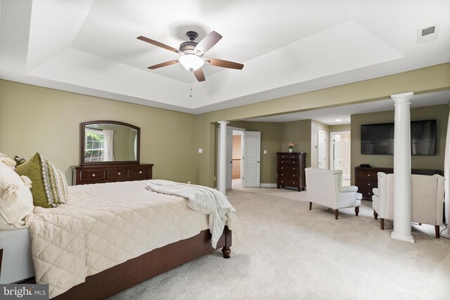 10701 Monocacy Way, Manassas, VA 20112 - bedroom featuring a tray ceiling, ornate columns, light carpet, connected bathroom, and ceiling fan