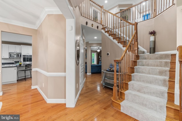 10701 Monocacy Way, Manassas, VA 20112 - stairway with crown molding, a ceiling fan, wood finished floors, and baseboards