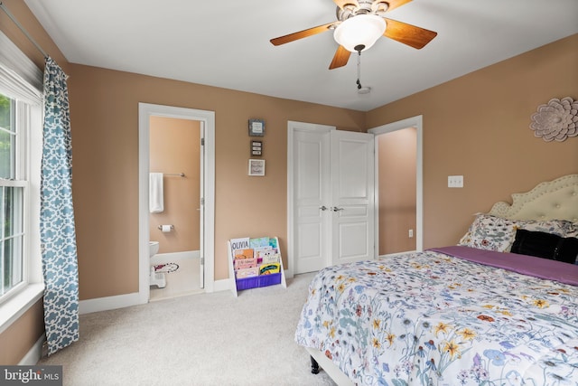 10701 Monocacy Way, Manassas, VA 20112 - carpeted bedroom with connected bathroom, baseboards, and ceiling fan