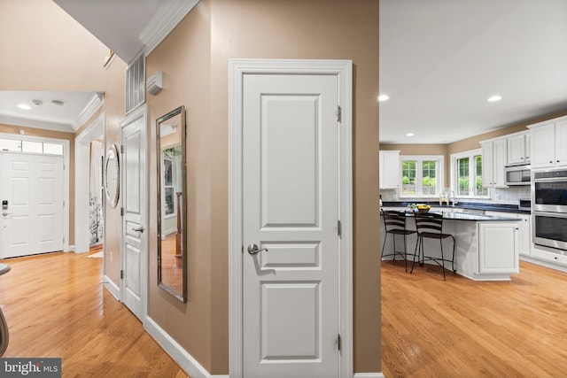 10701 Monocacy Way, Manassas, VA 20112 - corridor featuring crown molding, light wood finished floors, recessed lighting, and baseboards