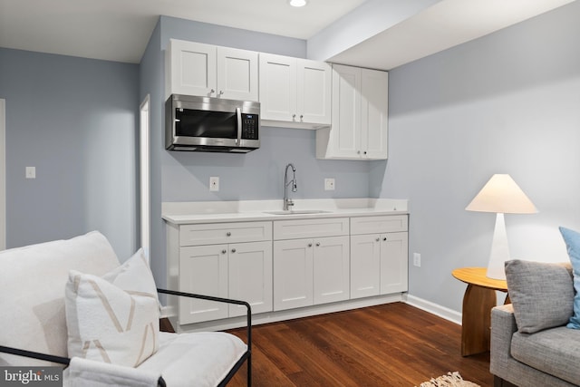 10701 Monocacy Way, Manassas, VA 20112 - kitchen with a sink, stainless steel microwave, light countertops, white cabinets, and dark wood-type flooring