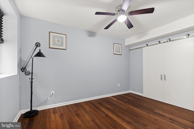 10701 Monocacy Way, Manassas, VA 20112 - unfurnished bedroom with dark wood-style flooring, baseboards, and a ceiling fan