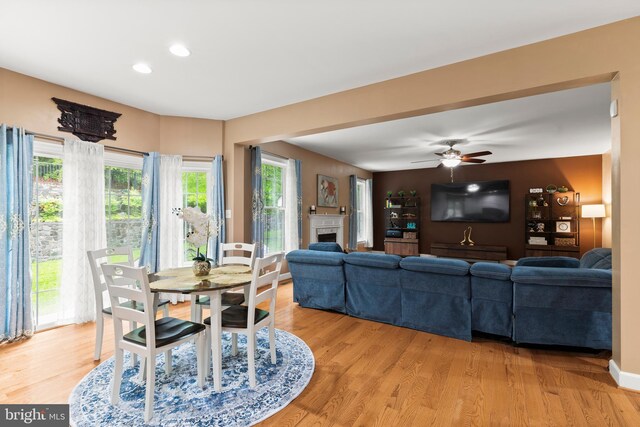 10701 Monocacy Way, Manassas, VA 20112 - dining room featuring a tiled fireplace, light wood-style flooring, recessed lighting, and a ceiling fan