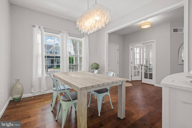 dining area with french doors, a chandelier, dark wood-type flooring, and baseboards