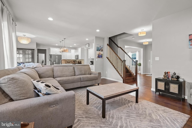 living room with dark wood finished floors, stairs, recessed lighting, and baseboards