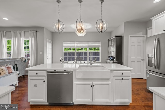kitchen featuring appliances with stainless steel finishes, a chandelier, a sink, recessed lighting, and plenty of natural light