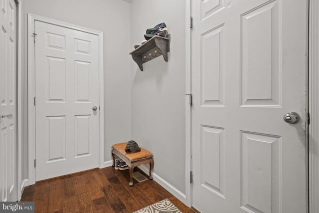 mudroom featuring dark wood finished floors and baseboards
