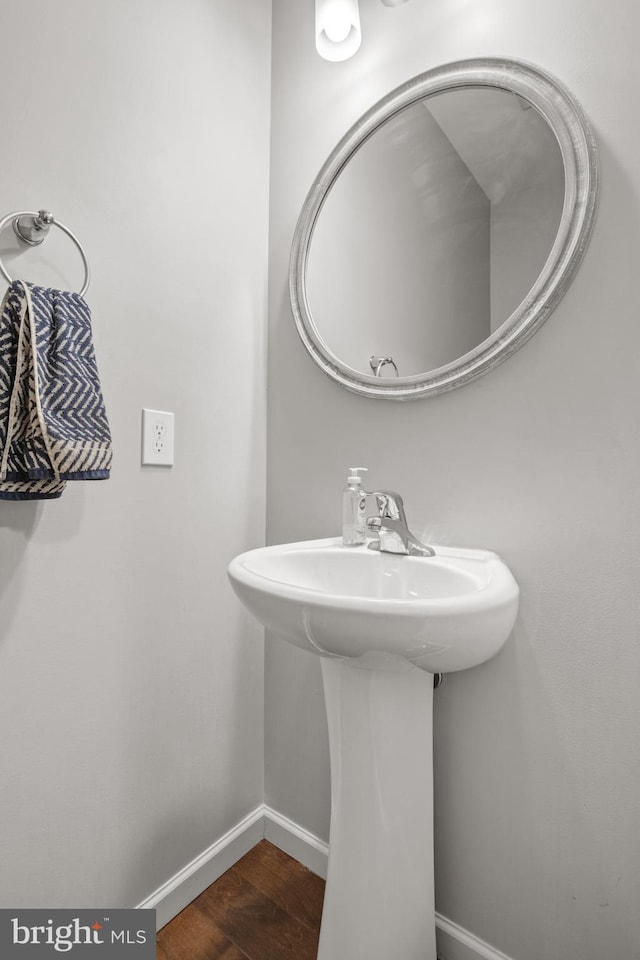 bathroom with wood finished floors and baseboards