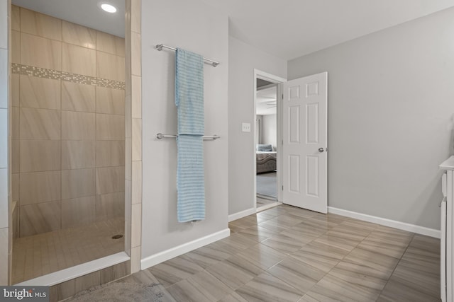 ensuite bathroom with walk in shower, baseboards, and recessed lighting