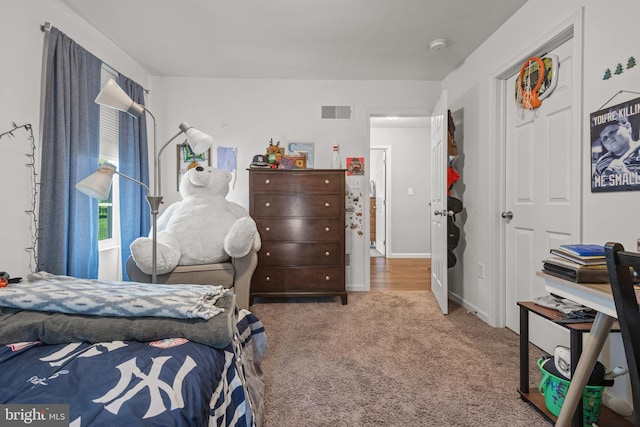 carpeted bedroom featuring baseboards