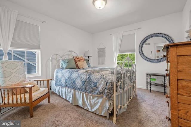 carpeted bedroom featuring baseboards