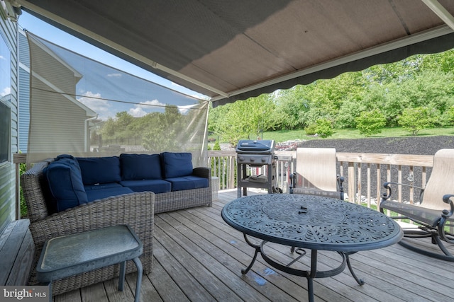 deck with outdoor lounge area and area for grilling