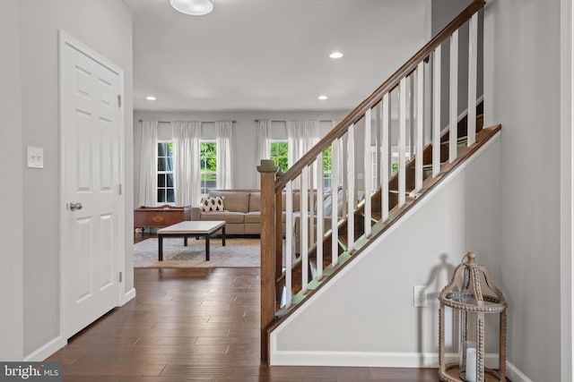 stairway with recessed lighting, baseboards, and wood finished floors