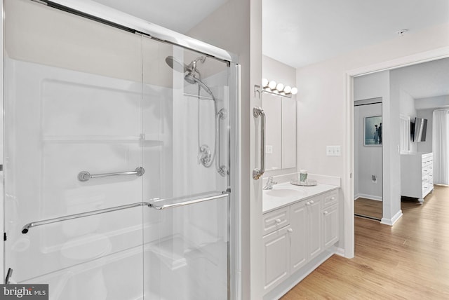 19355 Cypress Ridge Ter Unit 521, Leesburg, VA 20176 - bathroom featuring a shower stall, vanity, wood finished floors, and baseboards