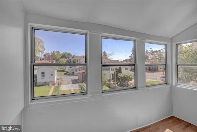 unfurnished sunroom with lofted ceiling