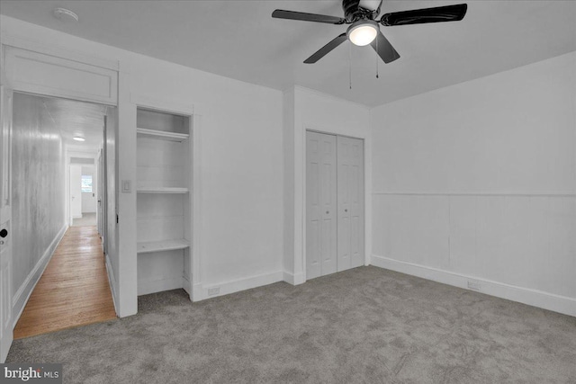 unfurnished bedroom with carpet floors, ceiling fan, and baseboards