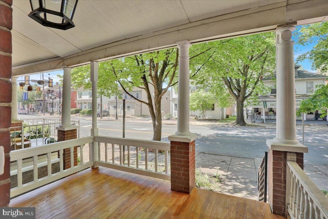 wooden terrace with a porch and a residential view