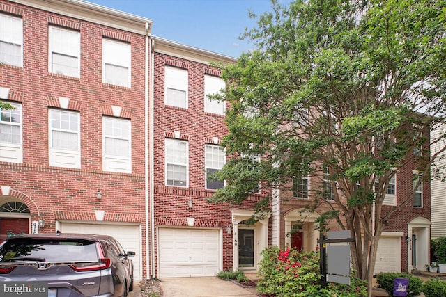 4160 Timber Log Way, Fairfax, VA 22030 - townhome / multi-family property with brick siding, an attached garage, and driveway