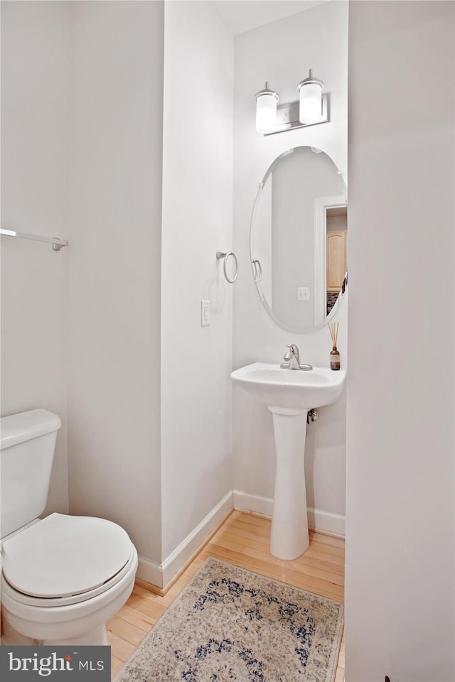 4160 Timber Log Way, Fairfax, VA 22030 - half bath with wood finished floors, toilet, and baseboards