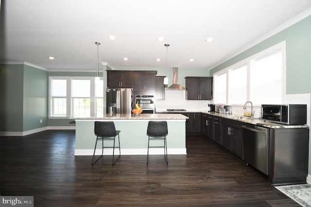 41 Green Dome Pl, Gaithersburg, MD 20878 - kitchen featuring stainless steel appliances, wall chimney exhaust hood, crown molding, a kitchen island with sink, and dark brown cabinets