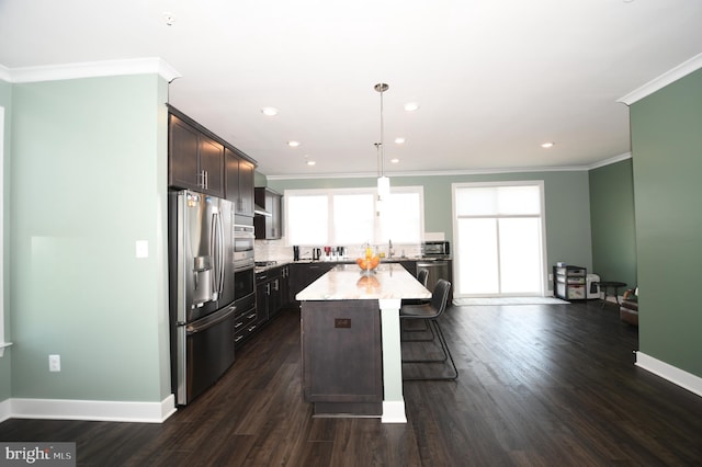 41 Green Dome Pl, Gaithersburg, MD 20878 - kitchen with appliances with stainless steel finishes, a kitchen island, crown molding, a breakfast bar area, and dark brown cabinets