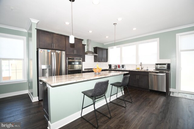 41 Green Dome Pl, Gaithersburg, MD 20878 - kitchen with appliances with stainless steel finishes, ornamental molding, a sink, wall chimney exhaust hood, and dark brown cabinetry
