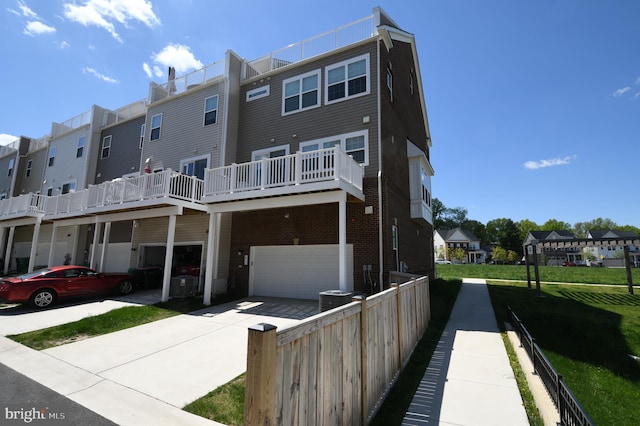 41 Green Dome Pl, Gaithersburg, MD 20878 - back of property with a garage, a residential view, driveway, fence, and brick siding