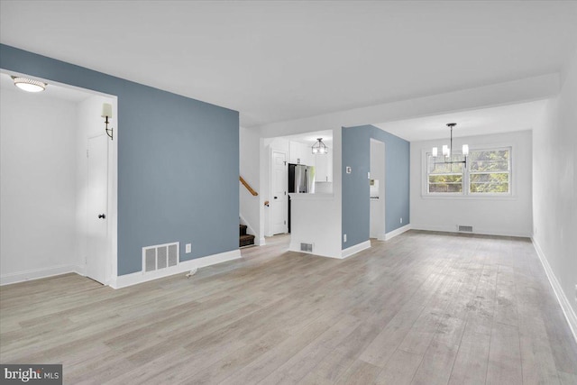 200 Boxwood Ln, Cinnaminson, NJ 08077 - unfurnished living room featuring a chandelier, light wood-style flooring, stairs, and baseboards