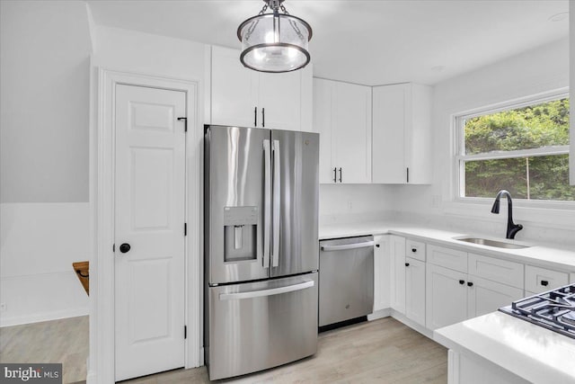 200 Boxwood Ln, Cinnaminson, NJ 08077 - kitchen with stainless steel appliances, a sink, white cabinetry, light wood-type flooring, and light countertops