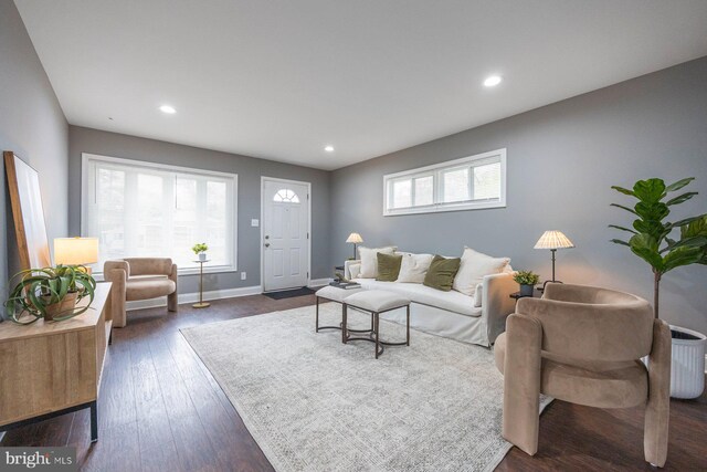 living area with recessed lighting, dark wood finished floors, and baseboards