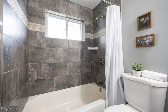 bathroom with toilet and shower / tub combo