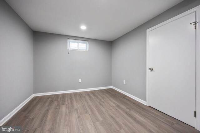 basement featuring wood finished floors, baseboards, and recessed lighting