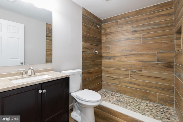 609 6th Ave, Brunswick, MD 21716 - bathroom with tiled shower, vanity, toilet, and wood finished floors