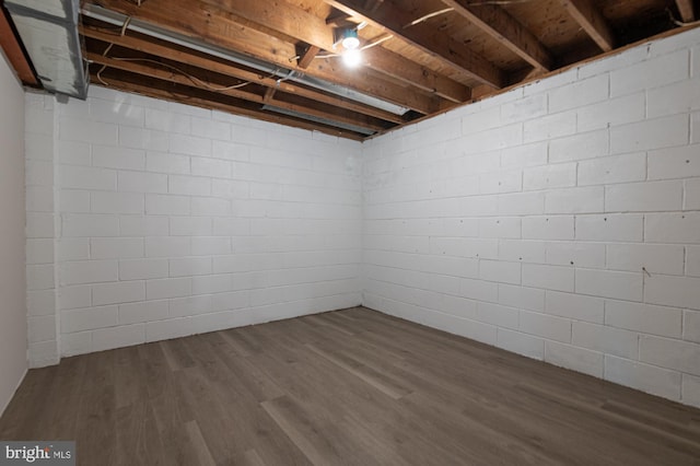 609 6th Ave, Brunswick, MD 21716 - unfinished basement featuring dark wood-style floors and concrete block wall