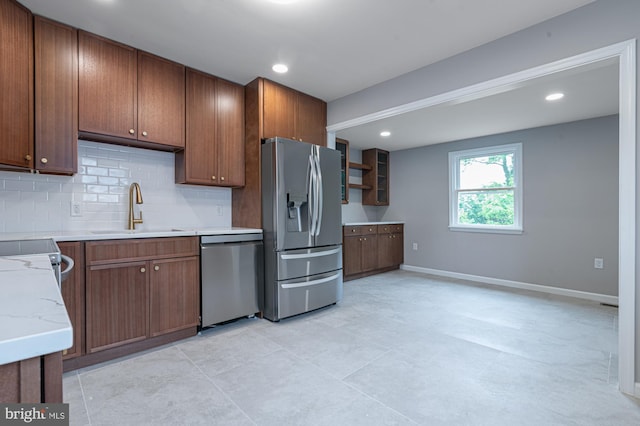 609 6th Ave, Brunswick, MD 21716 - kitchen with appliances with stainless steel finishes, a sink, backsplash, baseboards, and brown cabinets