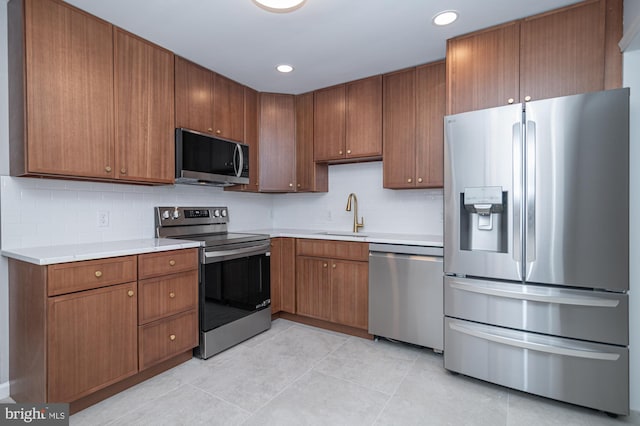 609 6th Ave, Brunswick, MD 21716 - kitchen featuring appliances with stainless steel finishes, a sink, decorative backsplash, light countertops, and light tile patterned floors