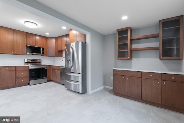 609 6th Ave, Brunswick, MD 21716 - kitchen featuring stainless steel appliances, light countertops, baseboards, open shelves, and glass insert cabinets