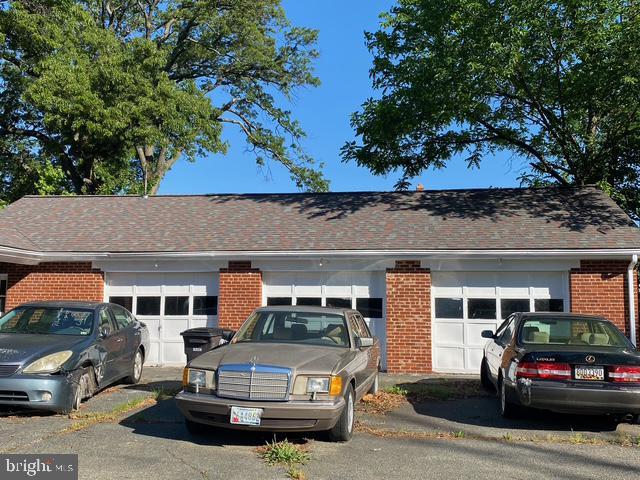 view of front of house featuring brick siding and a shingled roof