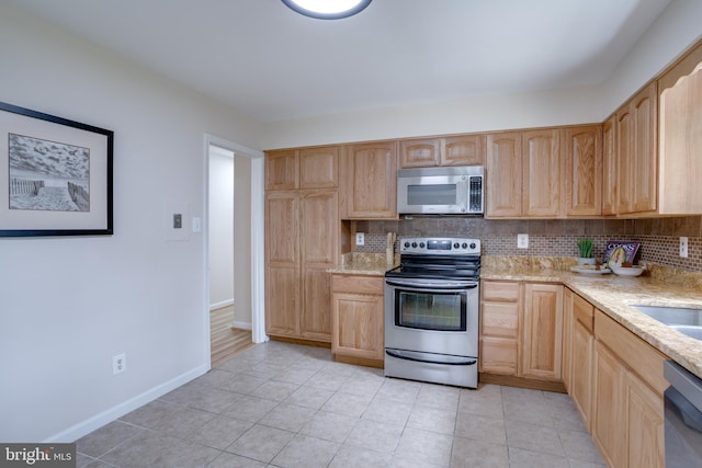 7923 Karl Rd, Alexandria, VA 22308 - kitchen with appliances with stainless steel finishes, light brown cabinets, backsplash, and baseboards