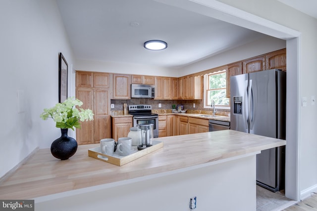 7923 Karl Rd, Alexandria, VA 22308 - kitchen with stainless steel appliances, decorative backsplash, light countertops, a sink, and baseboards