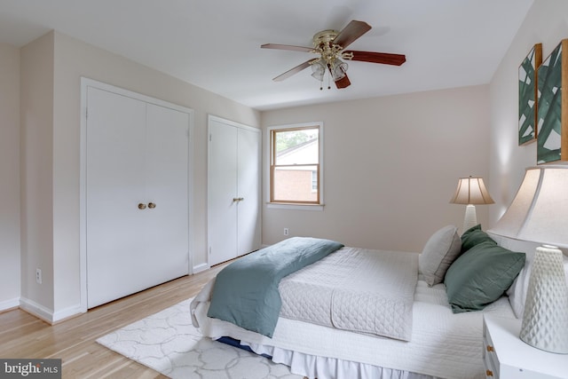 7923 Karl Rd, Alexandria, VA 22308 - bedroom with light wood finished floors, a ceiling fan, baseboards, and two closets