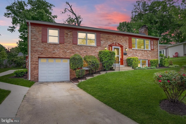 7923 Karl Rd, Alexandria, VA 22308 - raised ranch featuring an attached garage, driveway, a chimney, a front lawn, and brick siding