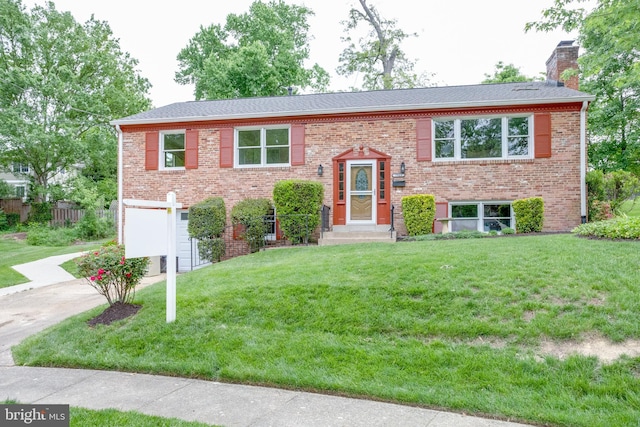 7923 Karl Rd, Alexandria, VA 22308 - raised ranch featuring an attached garage, concrete driveway, a chimney, a front yard, and brick siding