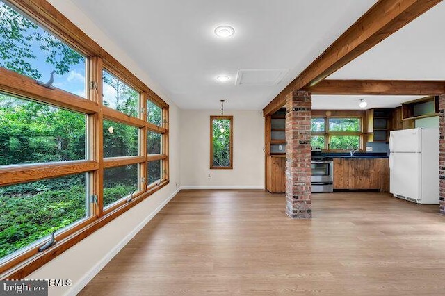 305 Nautilus Blvd, Forked River, NJ 08731 - unfurnished living room with baseboards, light wood-style floors, healthy amount of natural light, and a sink