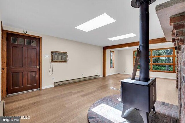305 Nautilus Blvd, Forked River, NJ 08731 - entryway with baseboard heating, a wood stove, wood finished floors, and baseboards