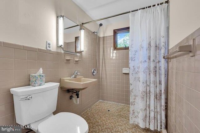305 Nautilus Blvd, Forked River, NJ 08731 - bathroom with tile walls, tiled shower, toilet, and a sink