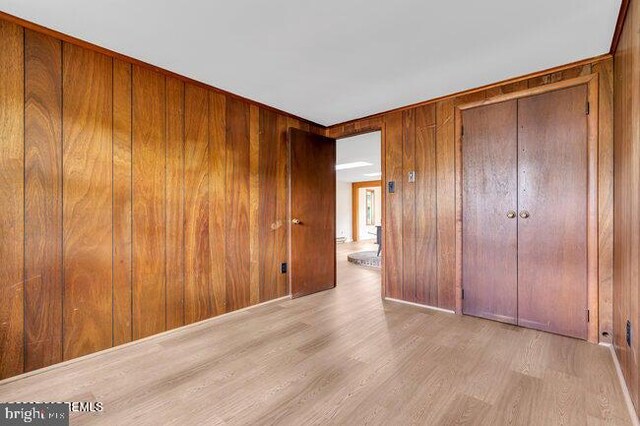305 Nautilus Blvd, Forked River, NJ 08731 - unfurnished bedroom with wood finished floors, wooden walls, and a closet