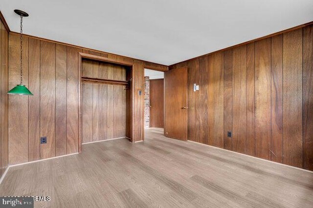 305 Nautilus Blvd, Forked River, NJ 08731 - unfurnished bedroom with wood finished floors, wooden walls, and a closet