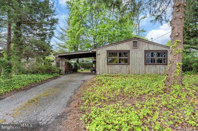 305 Nautilus Blvd, Forked River, NJ 08731 - view of outbuilding with asphalt driveway and a carport